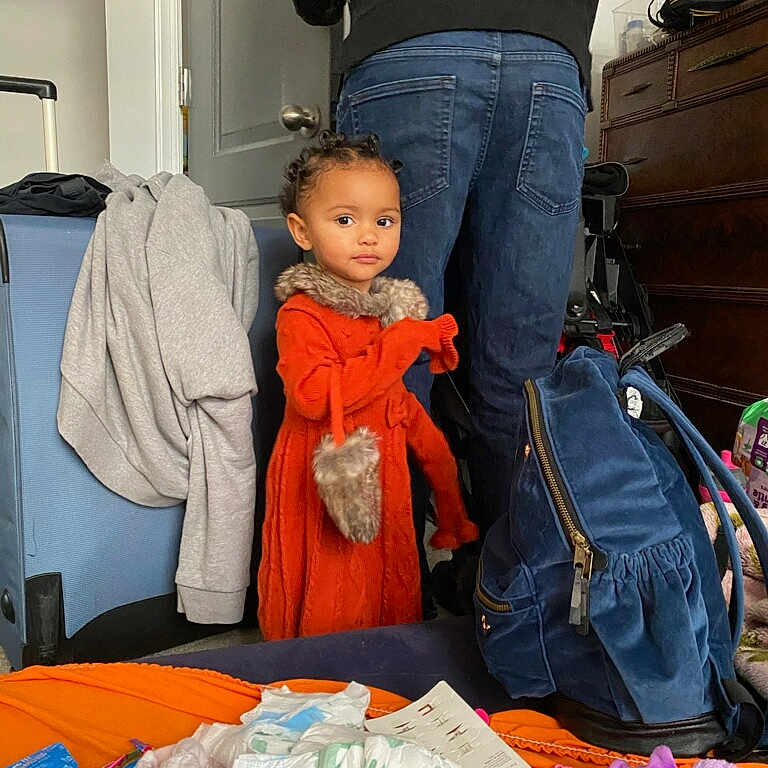 Cameryn is registered to the contest to win money with this photo: accessories, adult, baby, backpack, bag, baggage, clothing, face, furniture, handbag, head, jeans, male, man, pants, person, photography, portrait, suitcase, toy