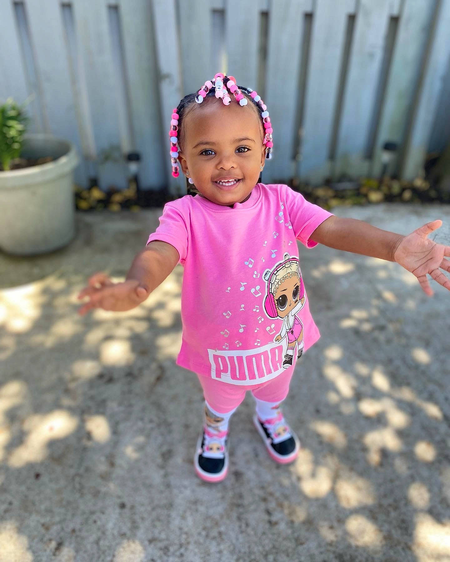 Sariyah is registered to the contest to win money with this photo: baby, baby_toddler_clothing, child, eye, flowerpot, fun, grass, happy, hat, houseplant, joy, magenta, person, pink, plant, purple, shoe, sleeve, smile, sneakers