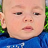Aaron joined the competition — help win amazing prizes! baby, infant, face, blue_shirt, grass, outdoor, expression, portrait, child, smiling_graphic, casual_clothing, head, skin, young_child, nature, person, closeup, cute, serious, toddler