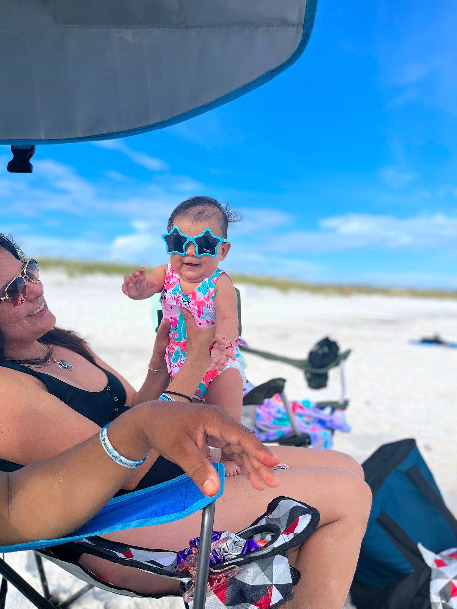Juliette is registered to the contest to win money with this photo: azure, beach, blue, body_of_water, brassiere, daytime, eyewear, fun, glasses, goggles, hat, joy, light, people_on_beach, person, shorts, sky, sunglasses, swimwear, thigh
