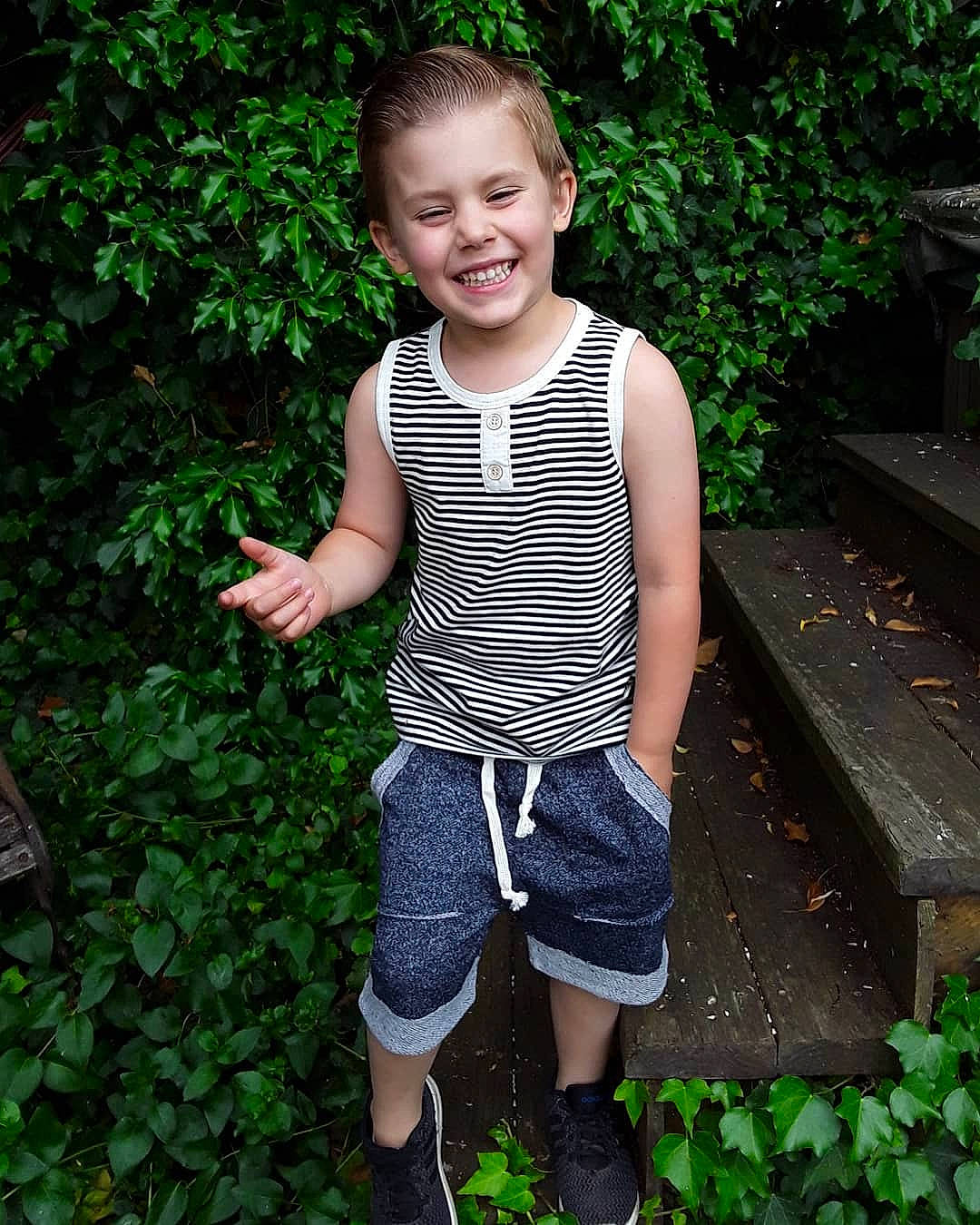 Deegan is registered to the contest to win money with this photo: child, child_model, denim, garden, jeans, joy, pattern, person, plant, shorts, smile, standing, summer, t_shirt, toddler, vacation