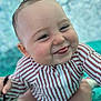 Ghjuvanni a rejoint le concours — aidez-le/la à gagner de superbes lots ! baby, cheeks, child, close_up, cute, expression, face, hands, happy, indoor, person, playful, portrait, sitting, skin, smiling, soft_focus, striped_clothing, tongue_out, young_child