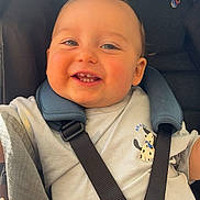 Ghjuvanni participe au concours pour gagner de l'argent avec cette photo : baby, babywear, child, childcare, clothing, cute, face, happy, head, indoor, infant, person, portrait, seat, seatbelt, sitting, smiling, stroller, teeth, young