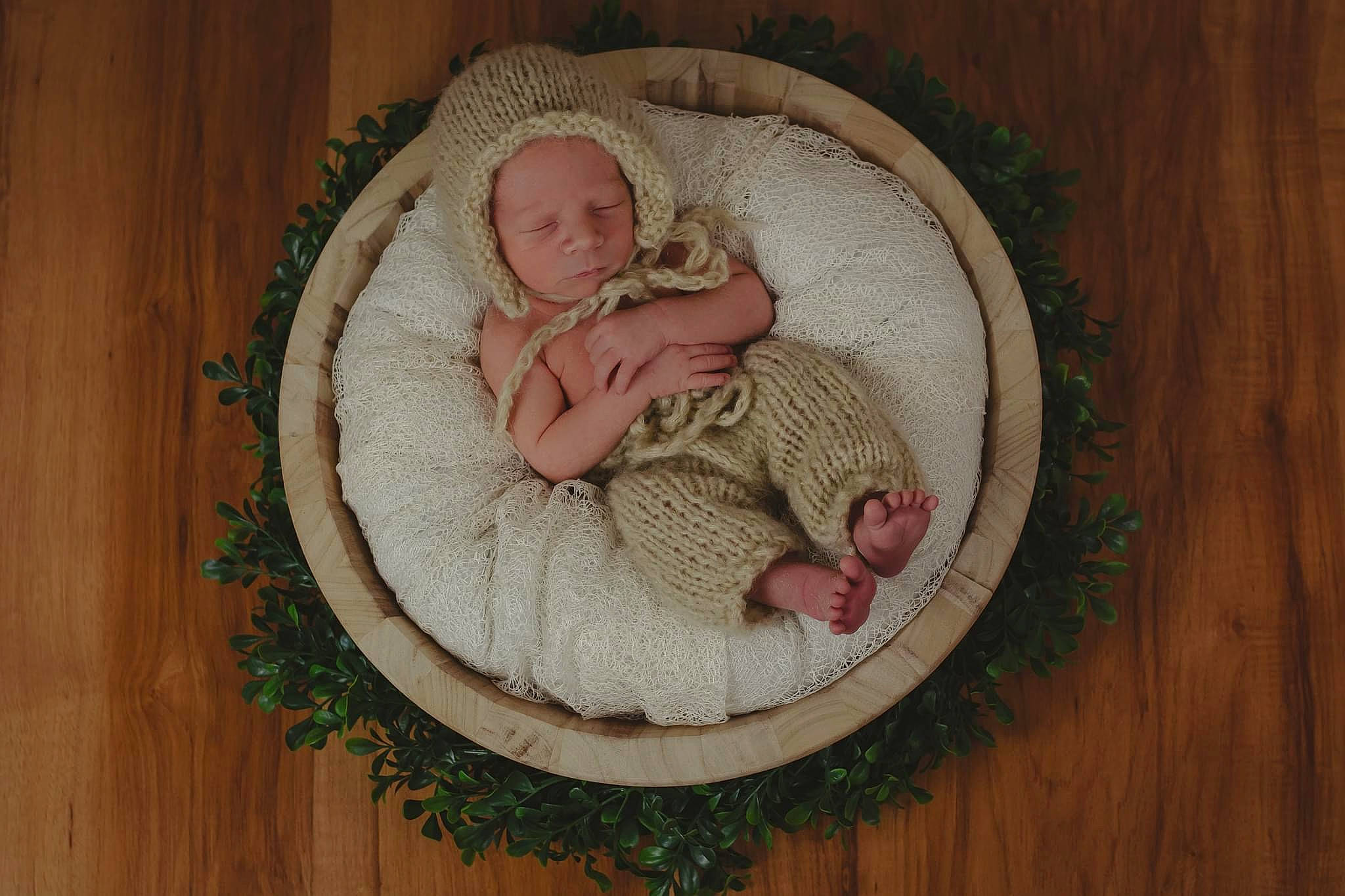 Jai is registered to the contest to win money with this photo: baby, baby_products, baby_sleeping, baby_toddler_clothing, circle, comfort, fashion_accessory, grass, hardwood, head, headgear, human_body, infant_bed, linens, pattern, person, sleeve, textile, toddler, wood