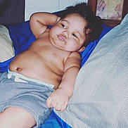 Deven is registered to the contest to win money with this photo: baby, blue_blanket, child, chubby, couch, diaper, drool, face, framed_photo, furniture, hair, hand, indoor, infant, pillow, portrait, relaxing, shorts, skin, wall