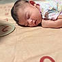 Jayleen is registered to the contest to win money with this photo: baby, sleeping, infant, blanket, numbers, pastel_colors, floral_pattern, soft_texture, peaceful, cute, child, skin, face, head, hand, lying_down, indoors, cozy, rest, nap