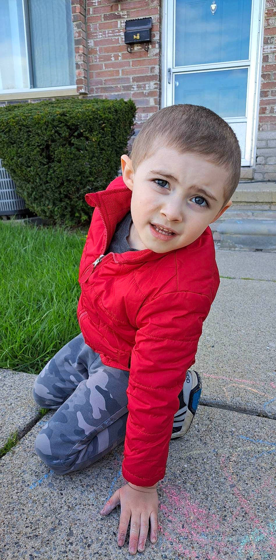 Johnnie is registered to the contest to win money with this photo: baby, baby_toddler_clothing, carmine, child, denim, electric_blue, flooring, fun, grass, hair, happy, head, hedge, nose, person, plant, sitting, sleeve, smile, toddler