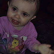 Scarlett is registered to the contest to win money with this photo: toddler, child, smiling, pajamas, pink_clothing, indoor, person, face, hand, cute, young_child, portrait, dark_background, carpet, floor, home, baby, expression, reaching, cozy