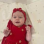 Apolline a rejoint le concours — aidez-le/la à gagner de superbes lots ! baby, child, clothing, cushion, cute, fabric, fist, happy, headband, headwear, indoors, infant, lying_down, pattern, person, portrait, red_dress, smile, star_pattern, young_child