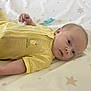 baby, child, crib_sheet, cute, expression, face, head, indoors, infant, lying_down, newborn, pacifier, portrait, resting, skin, sleepwear, small_hands, soft_lighting, star_pattern, yellow_outfit