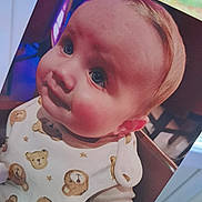 Logan-Benjamin joined the competition — help win amazing prizes! baby, child, face, blue_eyes, rosy_cheeks, bib, teddy_bear_pattern, clothing, indoor, furniture, window, natural_light, portrait, cute, infant, person, young_child, close_up, expression, seated