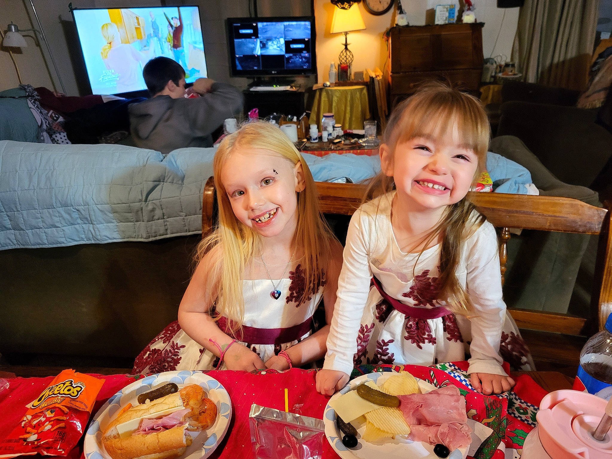 Samantha is registered to the contest to win money with this photo: cake, chair, child, couch, cuisine, dish, event, food, fun, furniture, home_appliance, joy, living_room, person, plate, sharing, smile, table, tableware, television