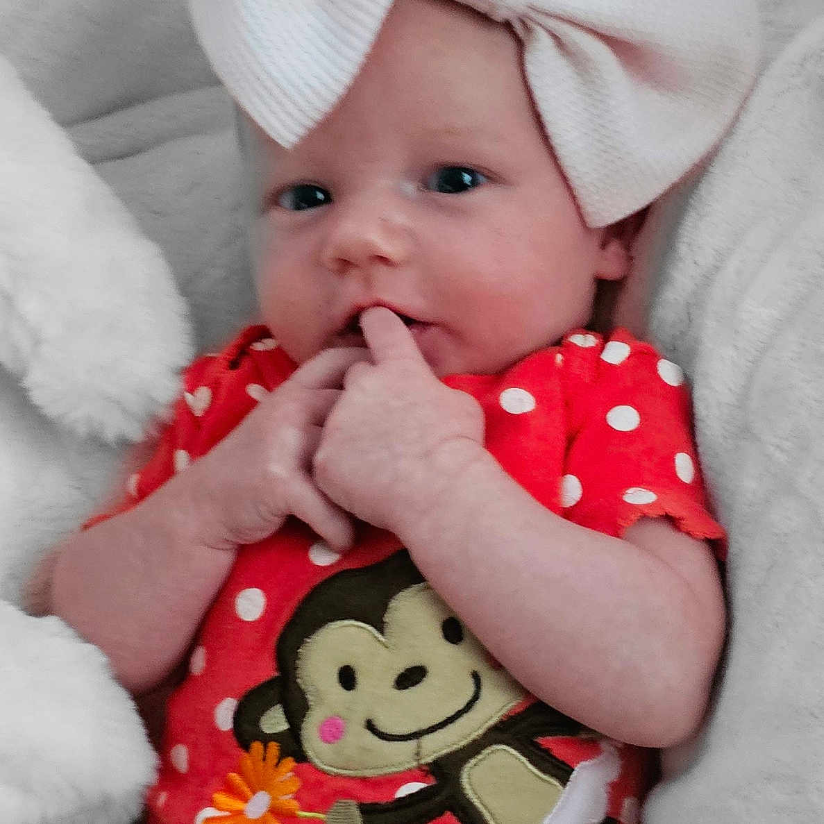 Essmae is registered to the contest to win money with this photo: baby, blanket, bodypart, bonnet, cap, clothing, couch, cushion, dress, face, finger, furniture, hand, hat, head, homedecor, newborn, person, photography, portrait