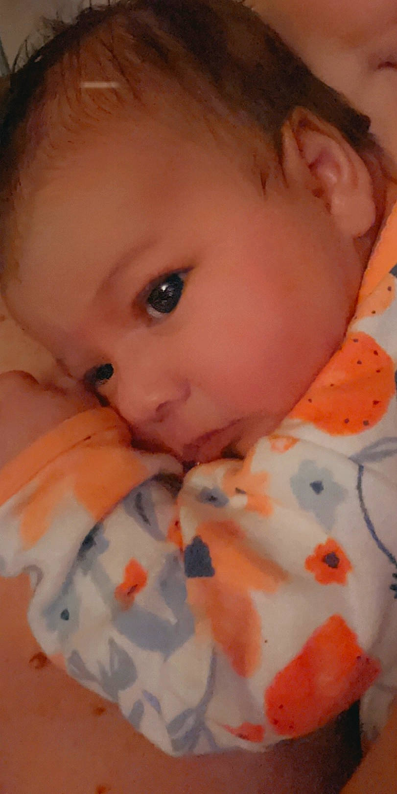 Brynlee is registered to the contest to win money with this photo: baby, cheek, chin, collar, comfort, eyebrow, eyelash, finger, forehead, gesture, human_body, iris, lip, mouth, neck, nose, orange, person, skin, sleeve