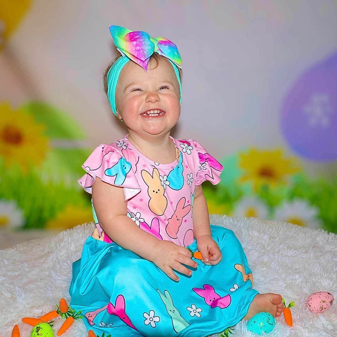 Kenslee is registered to the contest to win money with this photo: accessories, baby, babylaughing, clothing, costume, cream, dress, face, furniture, happy, hat, head, homedecor, laughing, person, photography, portrait, purple, sitting, smile