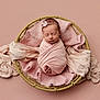 newborn, baby, swaddle, pink, basket, blanket, headband, sleeping, portrait, studio, soft_texture, tiny_toes, cute, infant, newborn_photoshoot, peaceful, wrapped, fabric, props, closeup