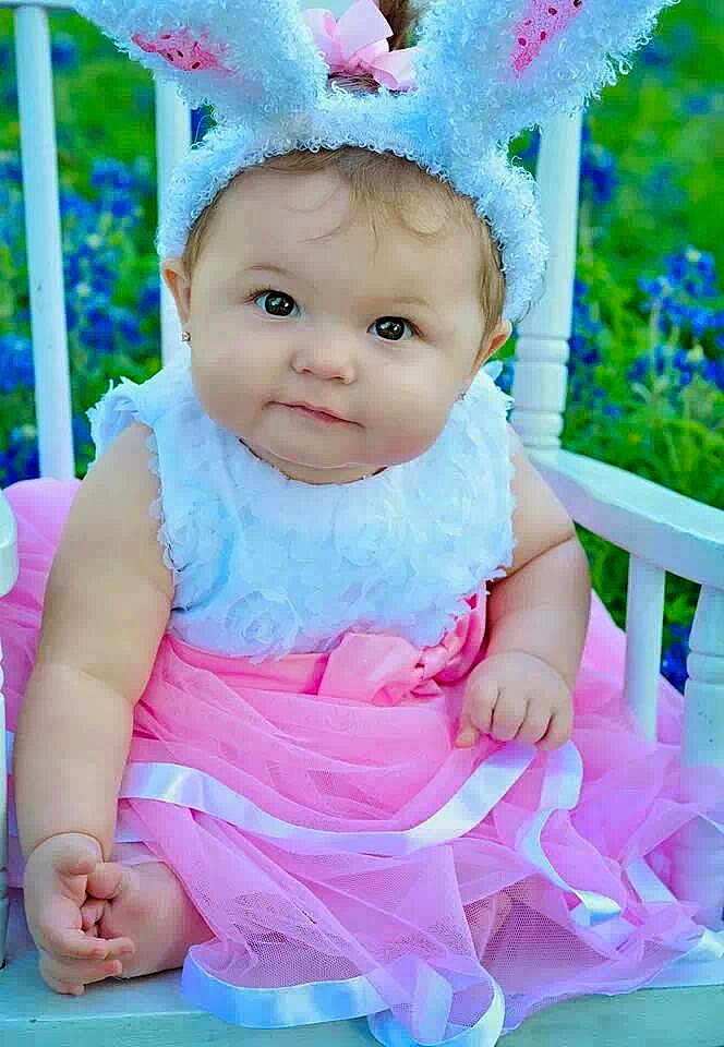 Isabelle joined the competition — help win amazing prizes! baby, child, bunny_ears, pink_skirt, white_top, rocking_chair, outdoor, flowers, blue_flowers, cute, adorable, portrait, sitting, curious, baby_girl, headband, nature, greenery, soft_fabric, smiling