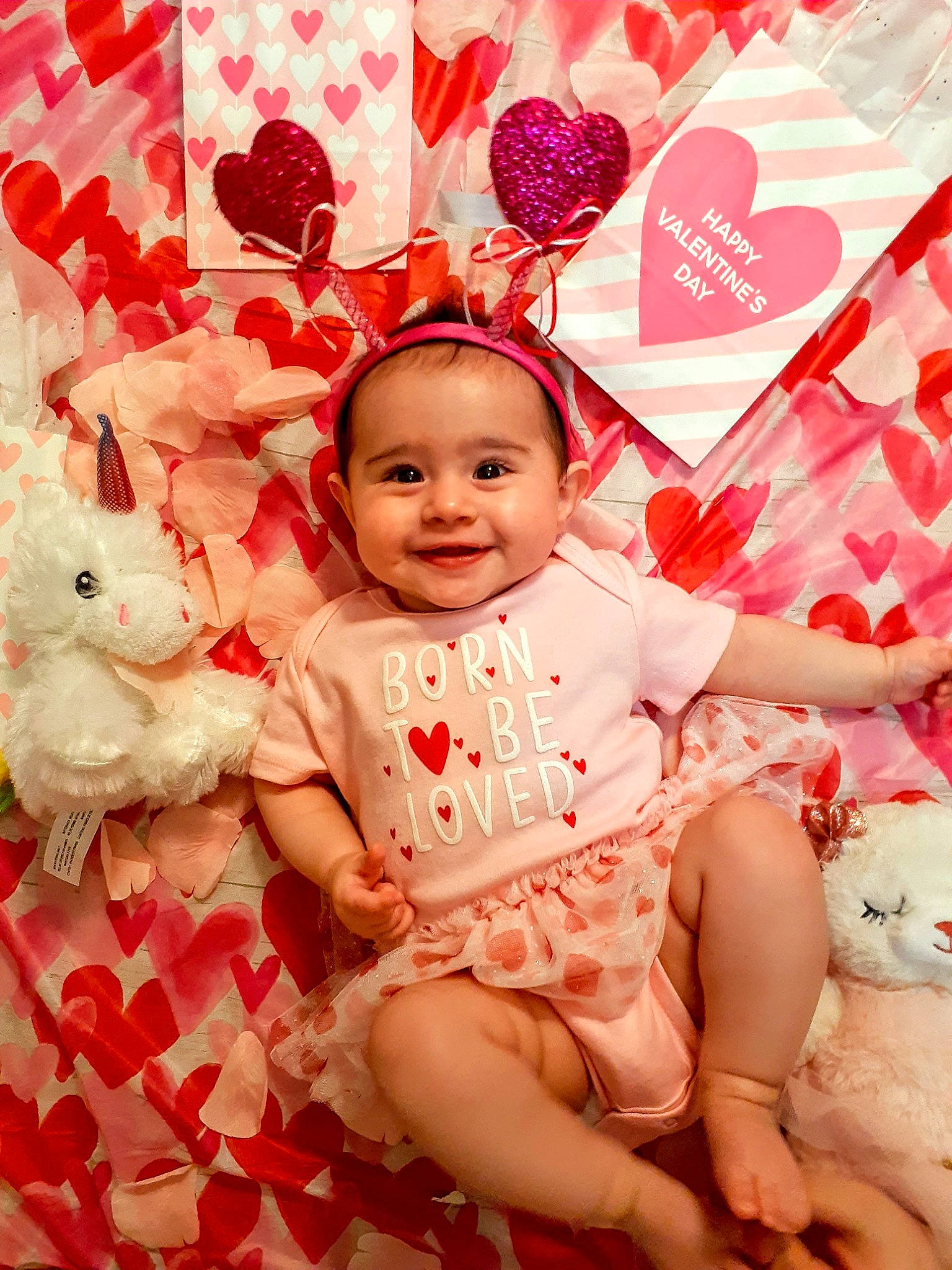 Christina is registered to the contest to win money with this photo: baby, baby_toddler_clothing, cheek, child, fun, happy, joy, linens, magenta, pattern, peach, person, pink, product, red, sitting, skin, sleeve, smile, sweetness