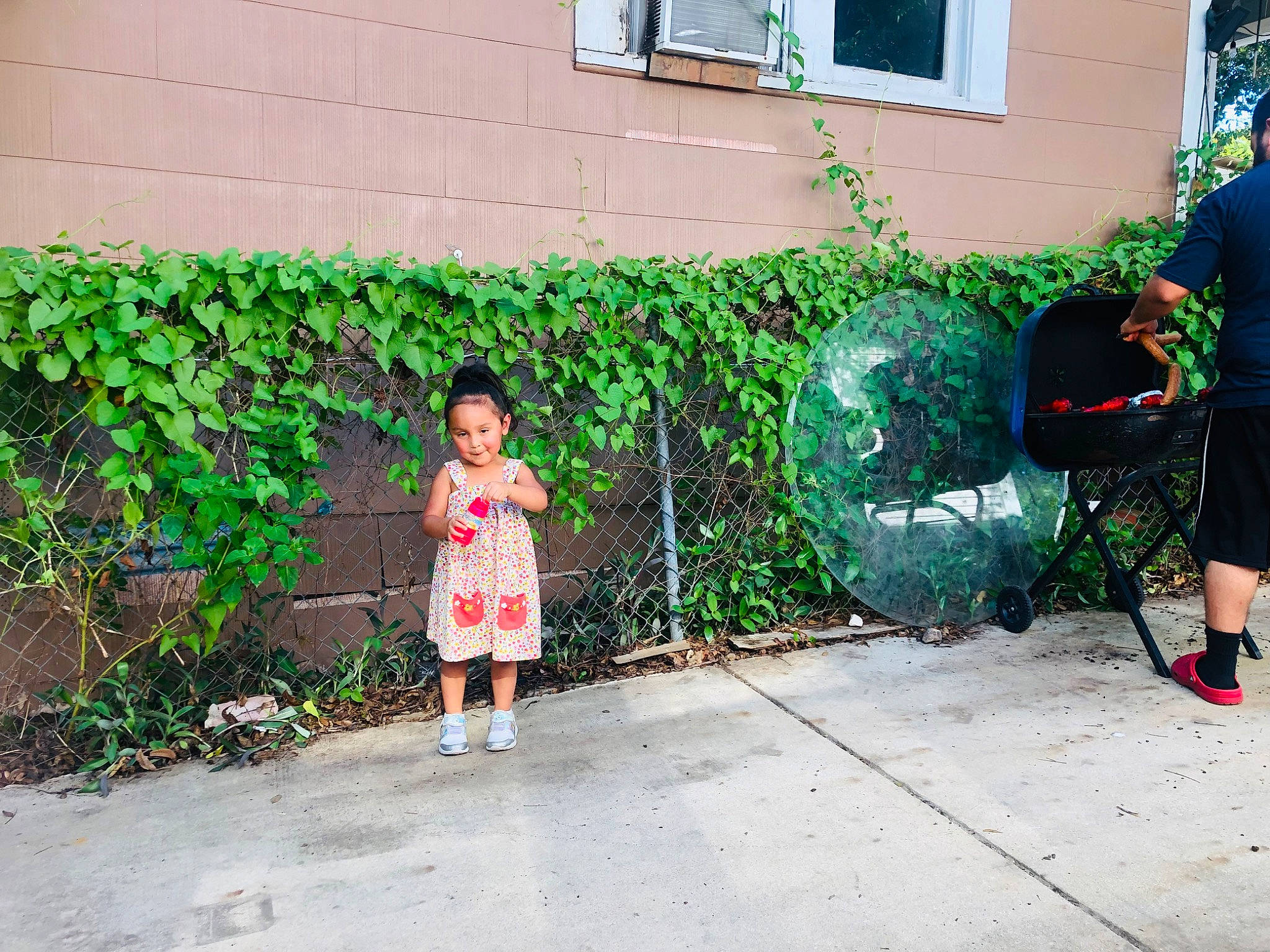 Avery joined the competition — help win amazing prizes! asphalt, backpack, garden, grass, green, joy, leaf, leisure, neighbourhood, person, plant, road, road_surface, shorts, shrub, sidewalk, standing, street, t_shirt, toddler