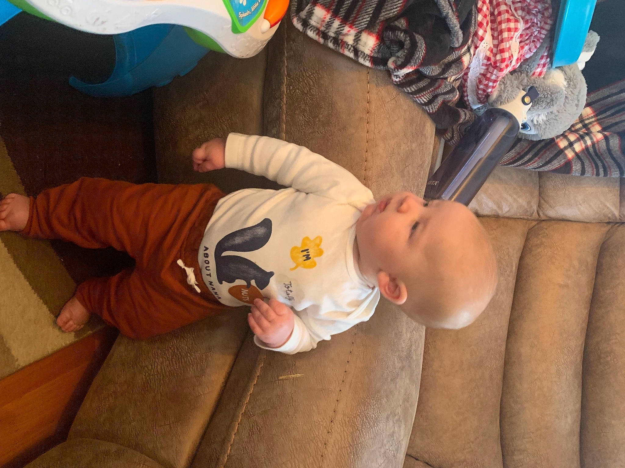 Tory joined the competition — help win amazing prizes! baby, baby_products, baby_safety, baby_toddler_clothing, child, comfort, facial_expression, finger, flooring, fun, hand, leg, person, room, sitting, skin, sleeve, sock, t_shirt, toddler