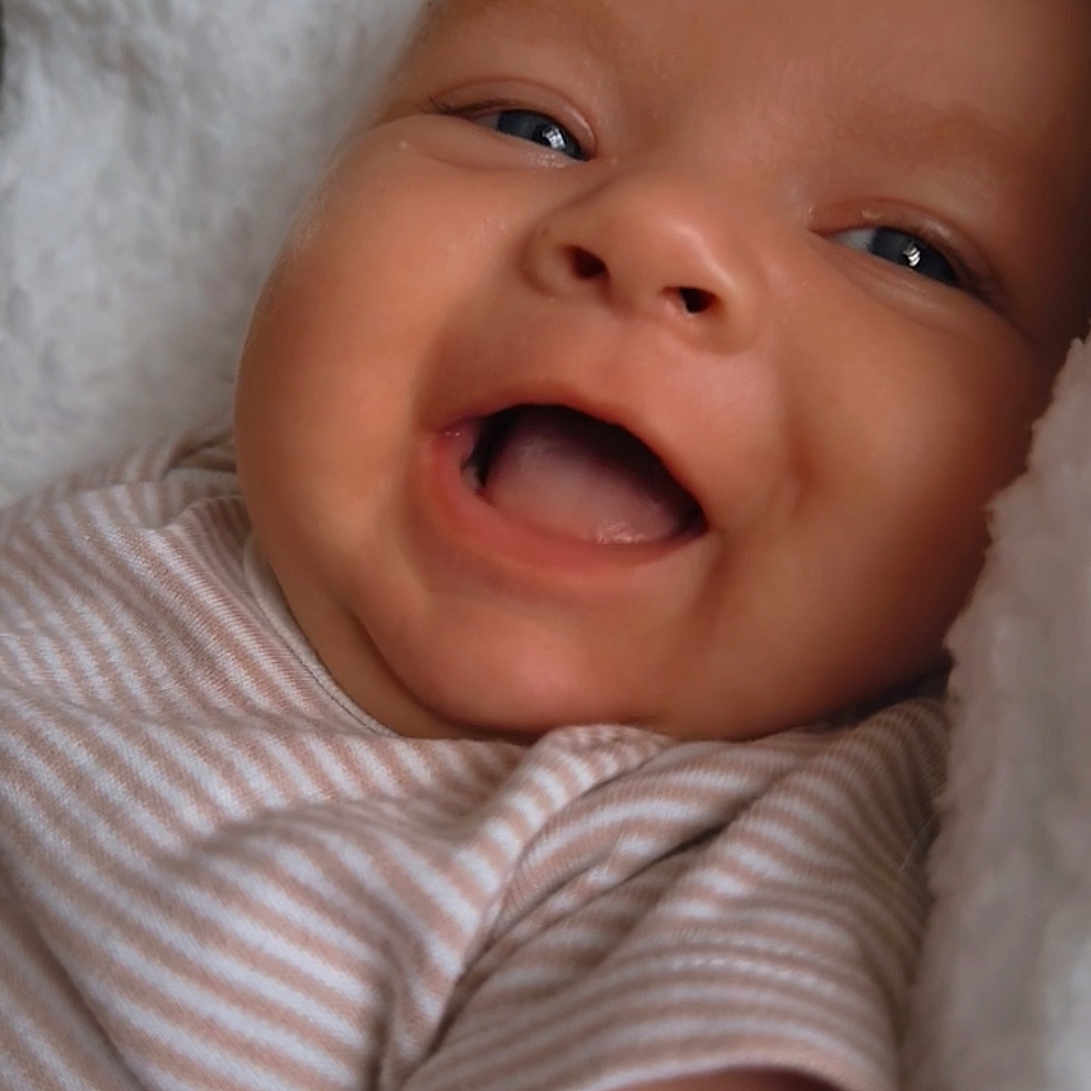 Kody-Blu joined the competition — help win amazing prizes! baby, blanket, blue_eyes, cheeks, child, closeup, comfort, cozy, cute, face, happy, infant, lying_down, mouth_open, newborn, portrait, skin, smiling, soft_texture, striped_clothing