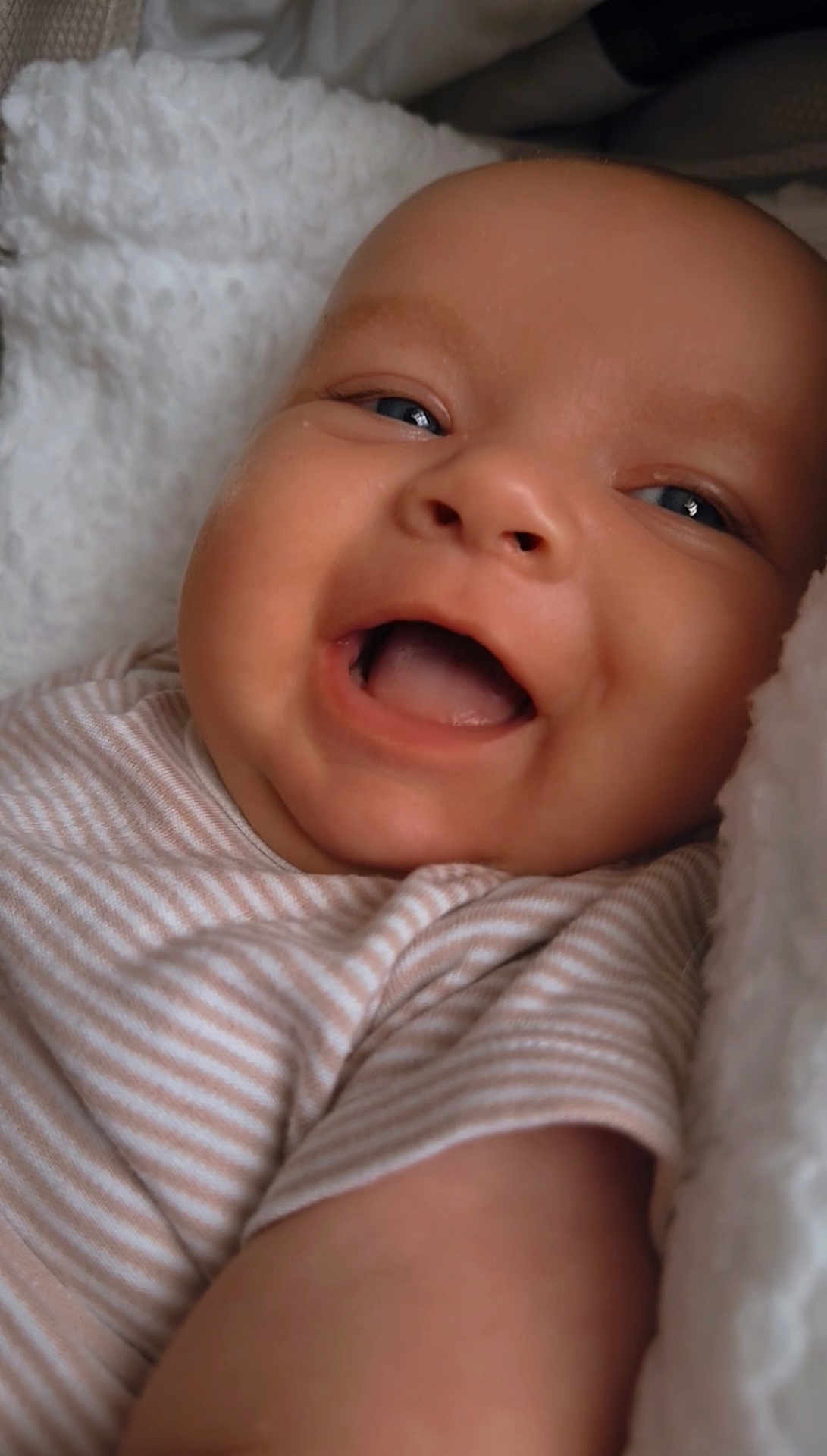 Kody-Blu joined the competition — help win amazing prizes! baby, smiling, face, blue_eyes, striped_clothing, blanket, closeup, infant, happy, cute, soft_texture, skin, cheeks, mouth_open, lying_down, newborn, child, portrait, cozy, comfort
