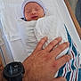newborn, baby, swaddled, sleeping, hospital, blanket, striped_cap, hand, wristwatch, bed, tenderness, infant, person, skin, rest, care, protection, quiet, hospital_bed, wrapped