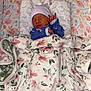 newborn, baby, sleeping, blanket, floral, hat, onesie, bed, bedding, cozy, infant, cute, soft, pink, blue, pattern, peaceful, child, resting, indoors