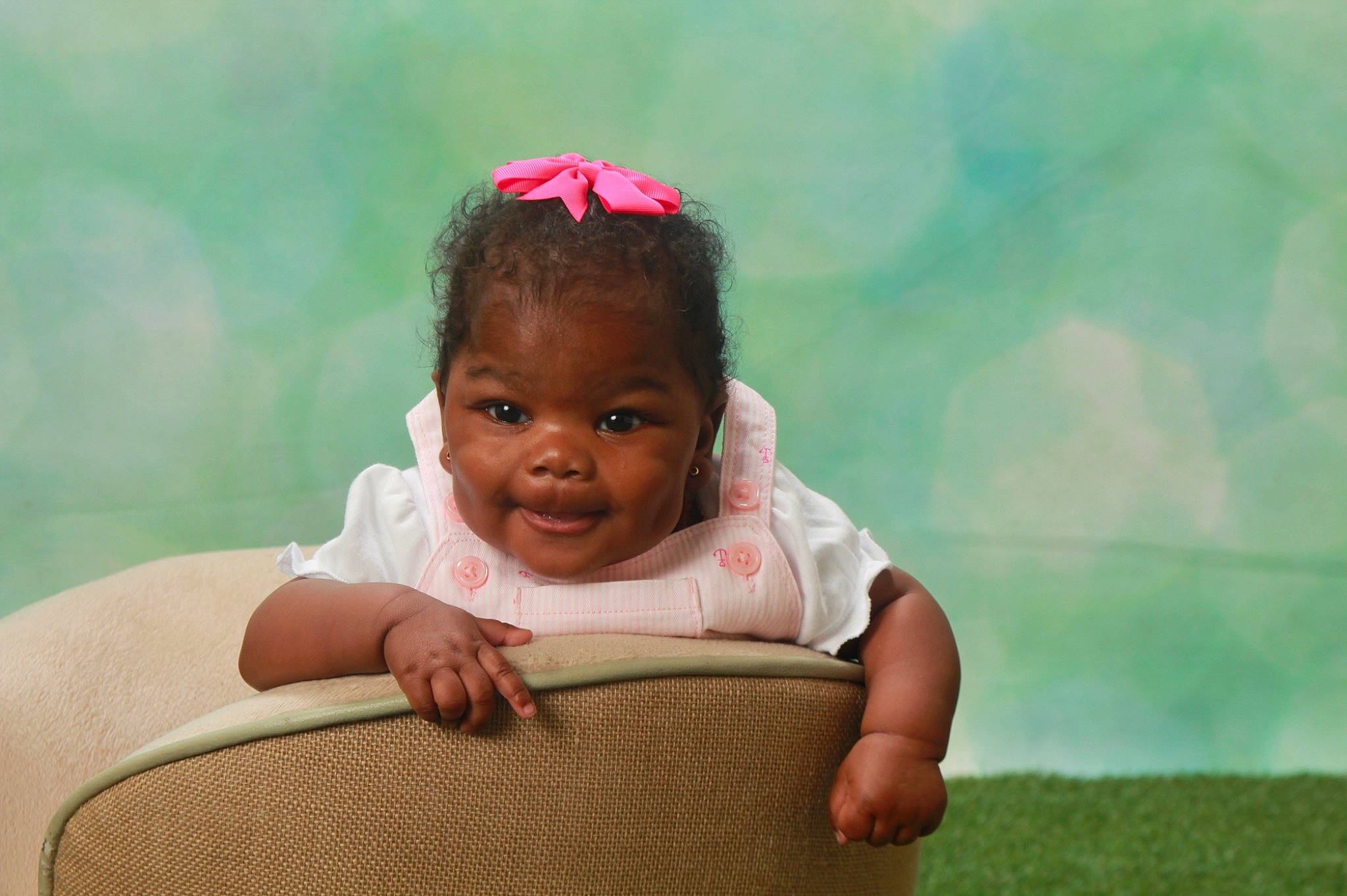 Denver is registered to the contest to win money with this photo: baby, child, fun, grass, happy, leisure, person, pink, sitting, skin, smile, toddler