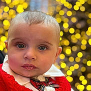 Jordan is registered to the contest to win money with this photo: baby, child, closeup, portrait, red_sweater, bow_tie, festive, holiday, bokeh, lights, cute, face, expression, clothing, young, indoors, person, eyelashes, head, soft_light