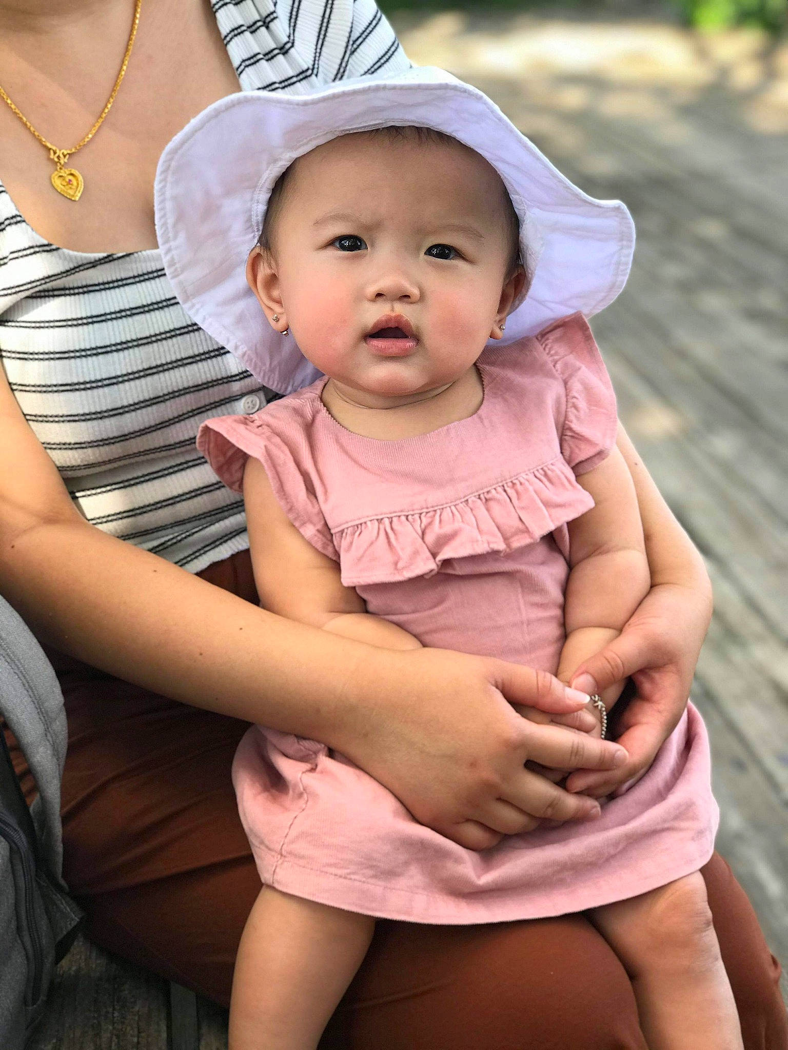 Noemi joined the competition — help win amazing prizes! baby, child, hat, headgear, headwear, leg, neck, person, sitting, skin, sun_hat, thigh, toddler