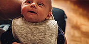 William participe au concours pour gagner de l'argent avec cette photo : adult, baby, background_blur, bib, child, closeup, cozy, cute, expression, face, hand, holding, indoor, infant, looking_up, person, portrait, skin, soft_texture, warm_light