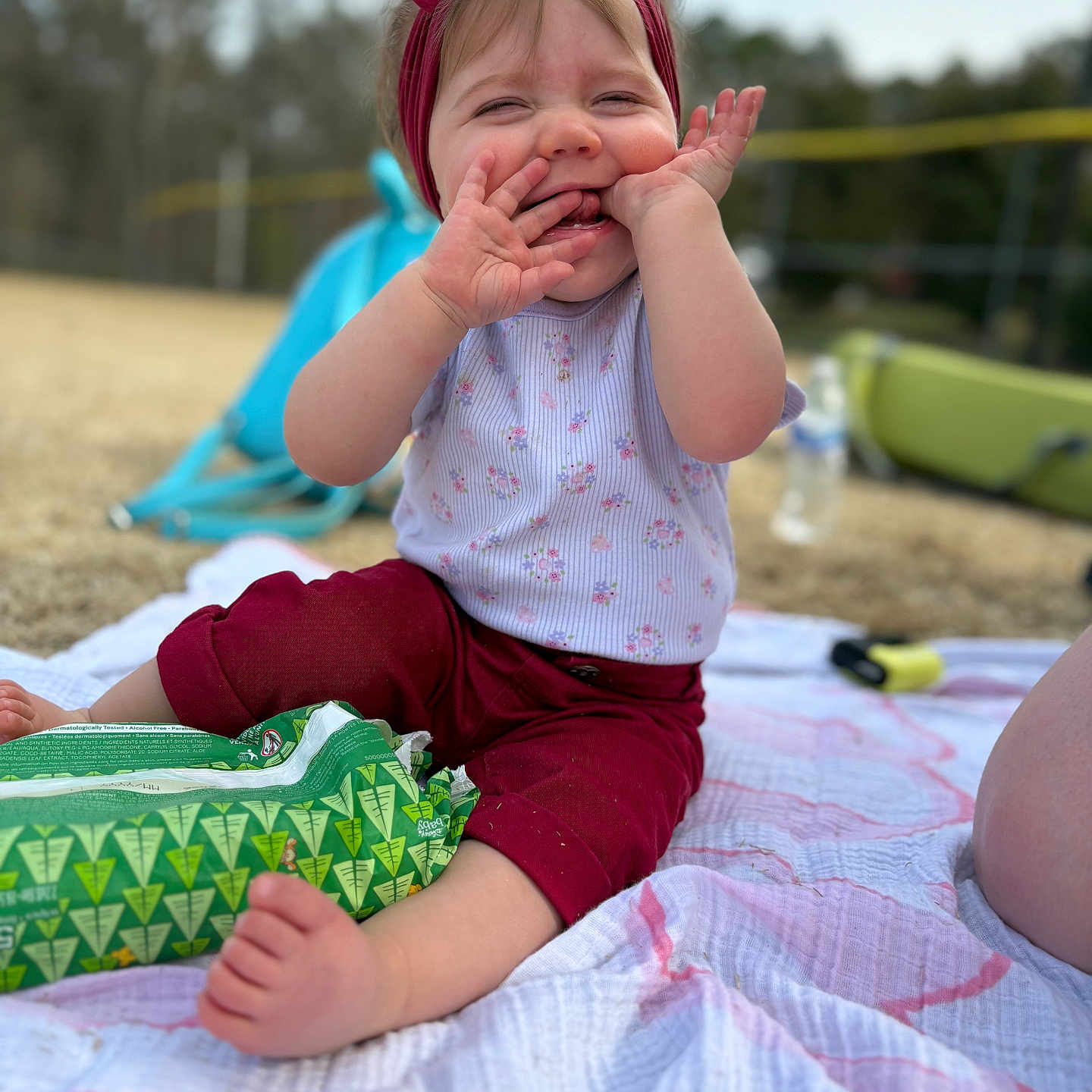 Maddilyn joined the competition — help win amazing prizes! baby, bodypart, clothing, crying, dress, face, finger, fun, hand, head, leisureactivities, person, photography, picnic, portrait, quilt, sad, shorts, sitting, t_shirt