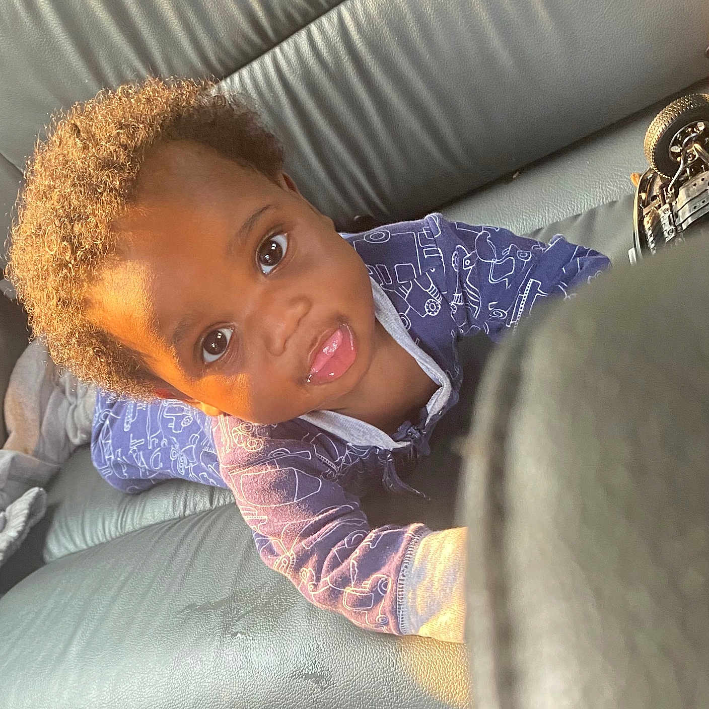 Tre'Mir joined the competition — help win amazing prizes! baby, blue_clothing, car_seat, child, curly_hair, cute, expression, face, indoor, leather, onesie, person, playful, portrait, reaching, seat, small, sunlight, toddler, young_child