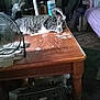 Baby joined the competition — help win amazing prizes! tabby_cat, cat, wooden_table, fan, cleaning_wipes, bag, person, indoor, relaxed, napping, household_items, floor_rug, furniture, living_room, window, air_conditioner, standing, clothing, purple_bedspread, casual