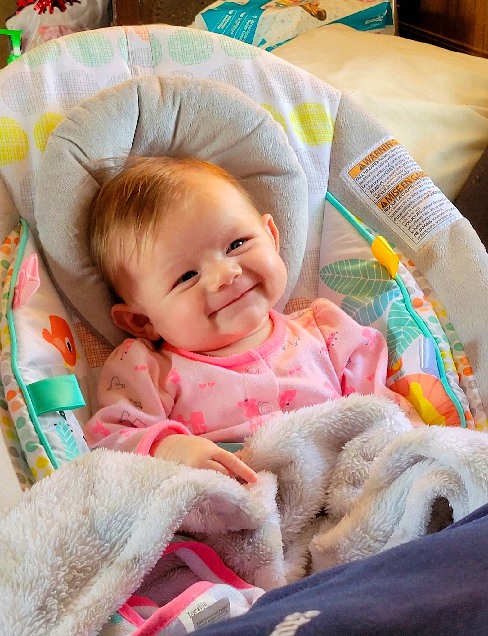 Huntley is registered to the contest to win money with this photo: baby, baby_laughing, baby_products, baby_toddler_clothing, cheek, child, comfort, facial_expression, fashion_accessory, fur, happy, head, iris, joy, linens, person, pink, sitting, skin, smile