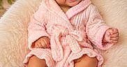 Antonella joined the competition — help win amazing prizes! baby, child, smiling, pink_robe, furry_chair, soft_lighting, fairy_lights, flowers, happy, cute, portrait, indoors, cozy, warm_colors, infant, sitting, skin, head, hands, feet