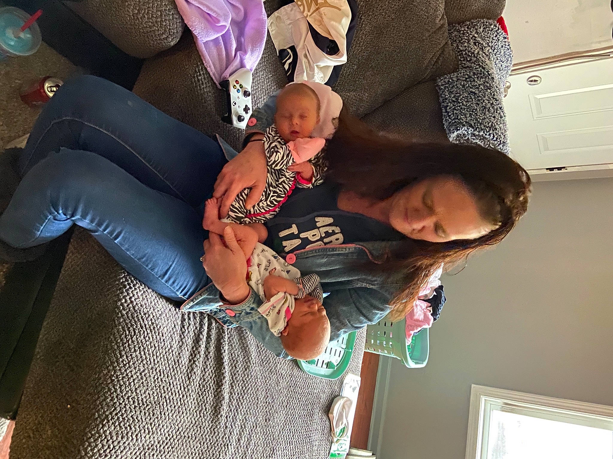 Emma is registered to the contest to win money with this photo: baby, baby_products, black_hair, child, comfort, dress, eyewear, fun, hairstyle, happy, human_leg, lap, mammal, nail, pattern, person, room, sitting, thigh, toddler