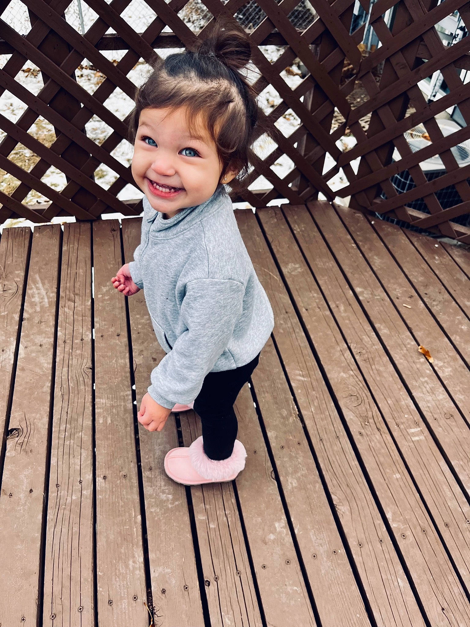 Kiana is registered to the contest to win money with this photo: baby_toddler_clothing, child, deck, flooring, fun, grass, happy, hardwood, human_leg, joy, leisure, pattern, people_in_nature, person, plank, sitting, skin, smile, standing, toddler