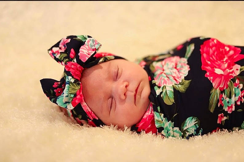 Maelynn joined the competition — help win amazing prizes! baby, baby_sleeping, baby_toddler_clothing, carmine, comfort, event, fashion_accessory, flower, grass, hair_accessory, happy, headband, headgear, headpiece, headwear, linens, pattern, person, petal, pink