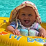 baby, child, pool, water, inflatable_ring, hat, sun_hat, smile, tongue_out, summer, swimming, floating, hand, bright, colorful, outdoor, fun, happy, cute, playful