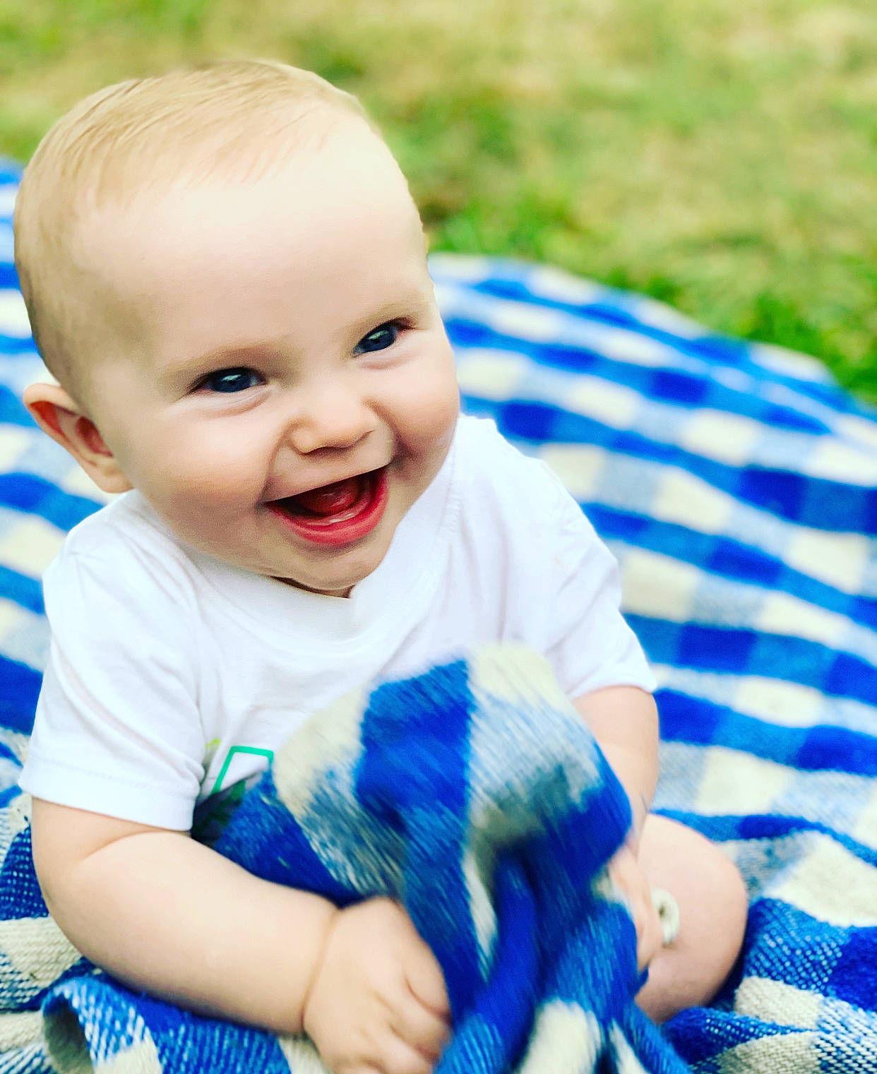 Richie is registered to the contest to win money with this photo: baby, blue, cheek, child, eye, face, facial_expression, grass, happy, joy, laugh, nose, people, person, photography, plant, play, portrait_photography, skin, smile