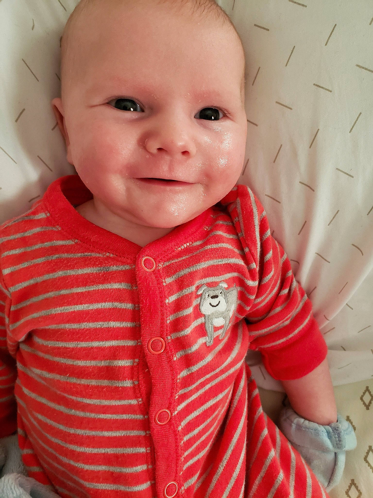 Richard is registered to the contest to win money with this photo: baby, baby_toddler_clothing, cheek, child, child_model, chin, eye, face, head, iris, lip, mouth, nose, outerwear, person, pink, red, skin, smile, standing