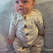 Levi is registered to the contest to win money with this photo: baby, infant, pajamas, striped_clothing, blanket, soft_fabric, cute, sitting, indoors, child, person, young, cozy, portrait, small_hands, face, head, feet, socks, sleepwear