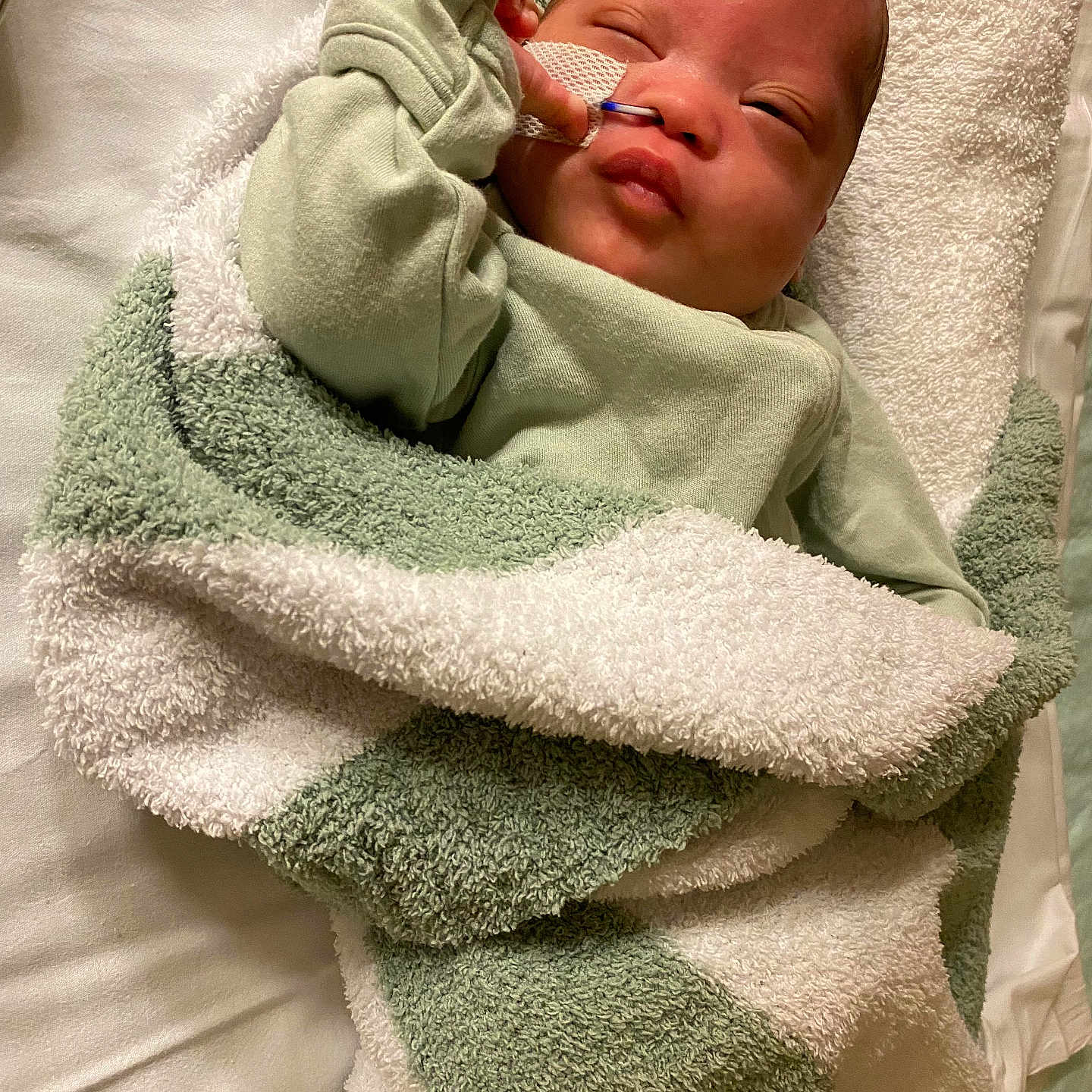 Jahlil is registered to the contest to win money with this photo: architecture, baby, bathtowel, blanket, building, face, head, hospital, newborn, person, photography, portrait, quilt, sleeping, towel