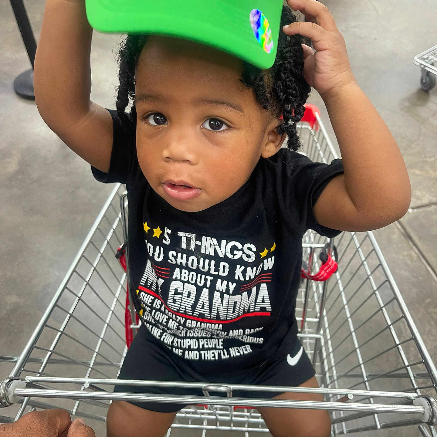 Kayden is registered to the contest to win money with this photo: adult, baseballcap, bodypart, boy, cap, child, clothing, face, finger, hand, hat, head, male, man, person, photography, portrait, shoppingcart, shorts, t_shirt