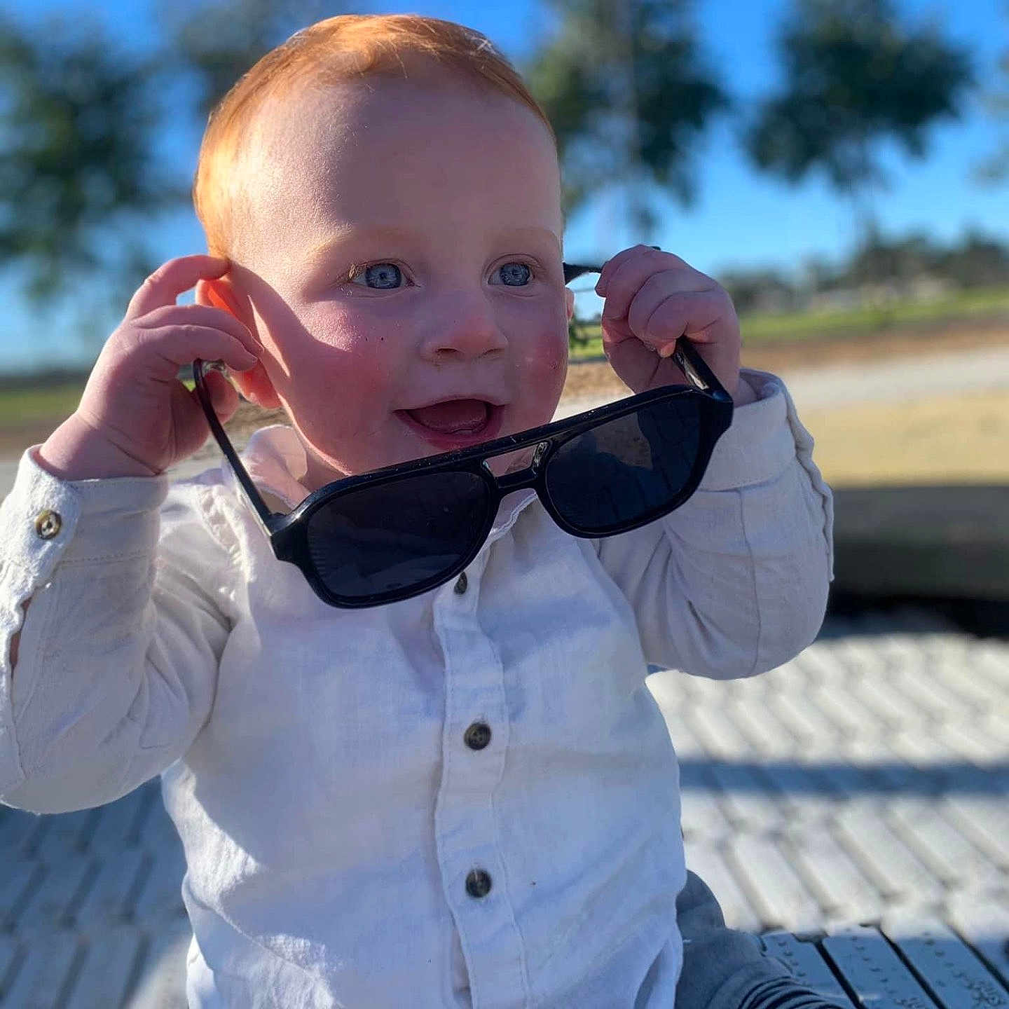 Syrus Billy-James joined the competition — help win amazing prizes! accessories, baby, bodypart, brownhair, clothing, face, finger, glasses, hair, hand, head, nature, outdoors, pants, person, photography, portrait, sitting, sleeve, sunglasses