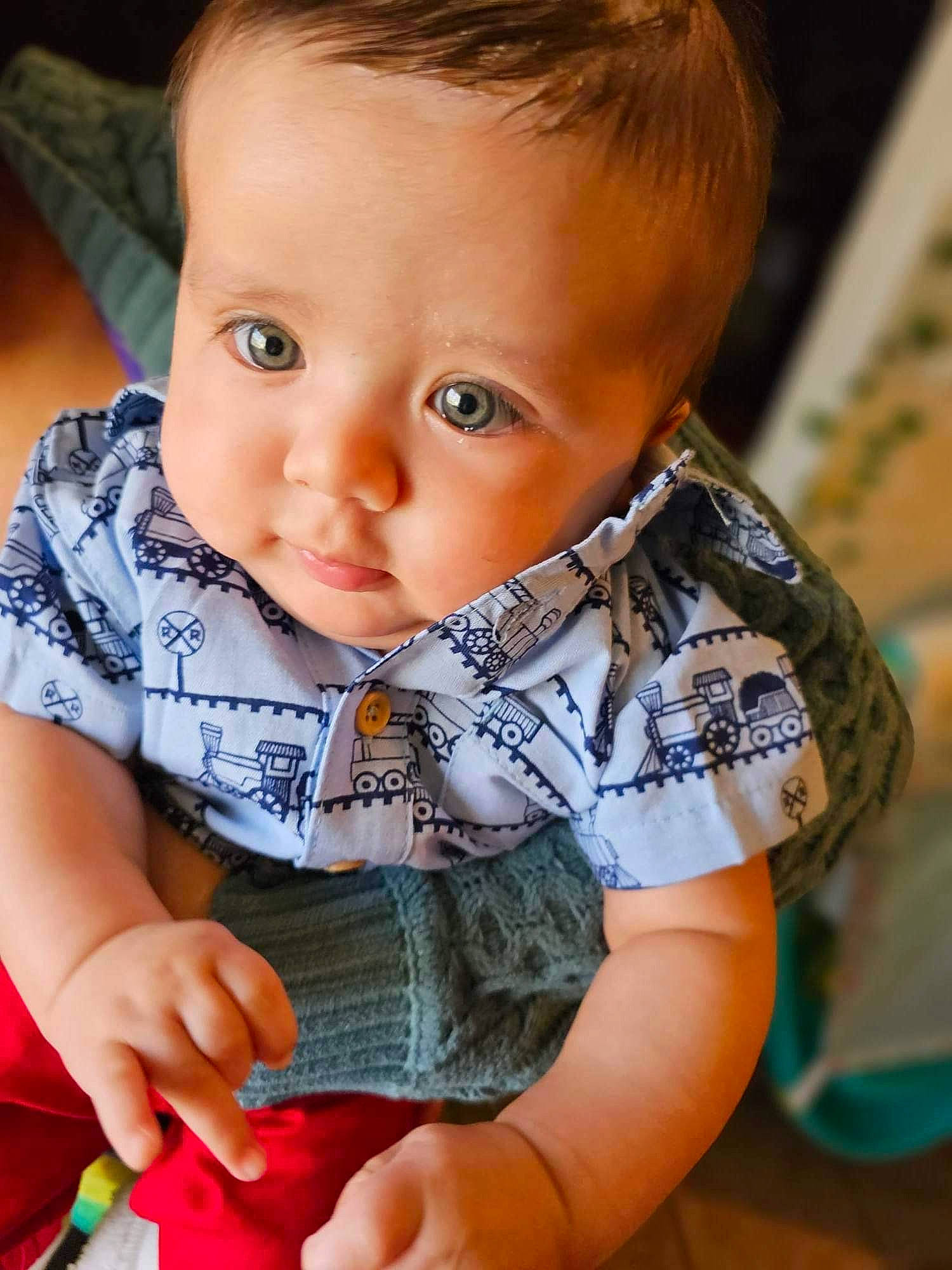 Maverick is registered to the contest to win money with this photo: arm, baby, baby_toddler_clothing, cheek, collar, dress, eye, eyelash, hand, happy, human_body, iris, lip, mouth, neck, nose, person, product, skin, sleeve