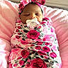 newborn, baby, sleeping, pacifier, swaddled, floral, rose_pattern, headband, bow, portrait, infant, face, indoors, blanket, pink, red, peaceful, nursery, close_up, photography