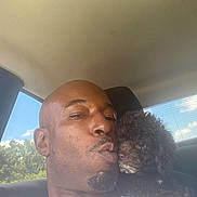 Summer Skye is registered to the contest to win money with this photo: affection, animal, car, casual_clothing, close_up, companion, curly_hair, daylight, dog, indoors, kiss, love, man, pet, portrait, seat, shoulder, sky, trees, window